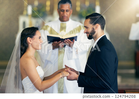 Couple getting married, wedding vows and love commitment at the alter of church during marriage ceremony. Happy bride, groom and Christian priest performing rites, religious and spiritual connection 124794208