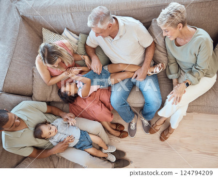 Interracial family, fun and sofa in a home living room with a happy mom, grandparents and children. Top view of happiness, smile and kids bonding with elderly people, mother and dad on a house couch Interracial family, fun and sofa in a home living room with a happy mom, grandparents and children. Top view of happiness, smile and kids bonding with elderly people, mother and dad on a house couch 124794209