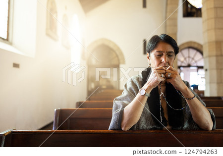 Pray, church and senior woman praying with a rosary in a calm, zen chapel alone, holy and spiritual. Prayer, worship and mexican lady connect with God, Jesus and christian religion in Mexico 124794263