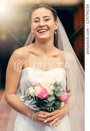 Beauty, fashion and portrait of a happy bride standing outdoor a church at a marriage ceremony. Romantic wedding, smile and beautiful married latino woman with a bouquet of flowers at event in dress 124794289