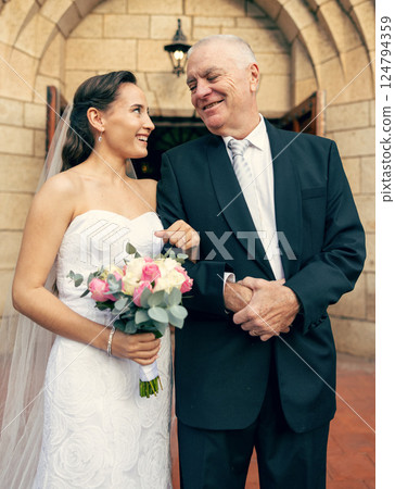 Wedding, love and father of the bride feeling happy, pride and support of family for event, celebration and marriage while together. Woman in bridal wear with senior man for tradition in a building Wedding, love and father of the bride feeling happy, pride and support of family for event, celebration and marriage while together. Woman in bridal wear with senior man for tradition in a building 124794359