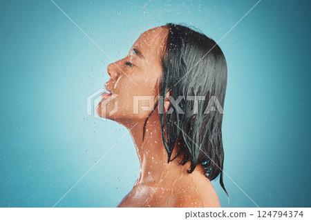 Woman, hygiene and wet shower for relax, beauty or fresh clean with water drops against a blue studio background. Relaxed female enjoying a hygienic wash and liquid sensation in cleanliness on mockup 124794374