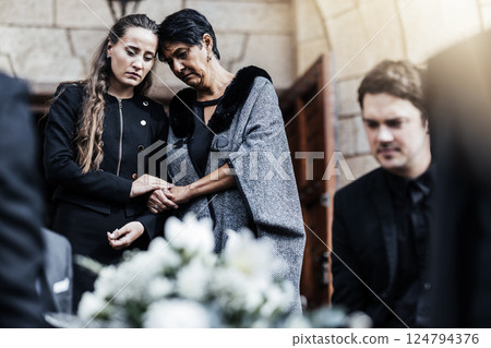 Funeral, senior mother and woman sad, crying and death in family, church and grief for loss of life. Young female comfort, care and support elderly mom after ceremony or service outdoor a chapel Funeral, senior mother and woman sad, crying and death in family, church and grief for loss of life. Young female comfort, care and support elderly mom after ceremony or service outdoor a chapel 124794376