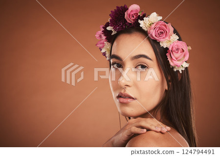 Face, beauty and flowers with a model woman in studio on a brown background with mockup to promote natural skincare. Wellness, portrait and luxury with an attractive young female wearing a wreath 124794491