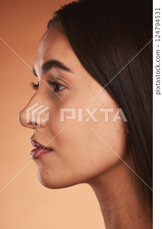 Skincare, woman with natural beauty and facial spa treatment with organic skin glow, cosmetic wellness and smooth makeup. Pretty model face, healthy hair and no cosmetics on orange studio background 124794531