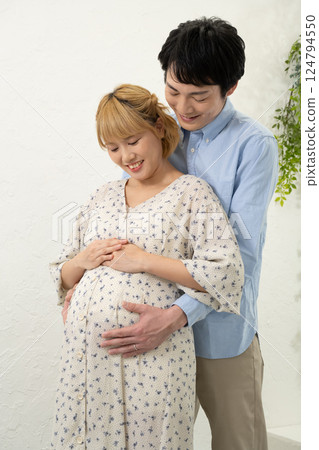 Husband supporting his pregnant wife Husband supporting his pregnant wife 124794550