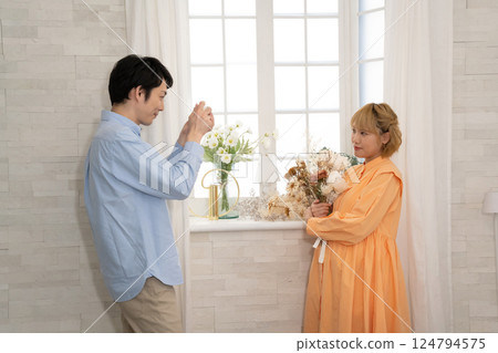 Husband taking pictures of his pregnant wife Husband taking pictures of his pregnant wife 124794575