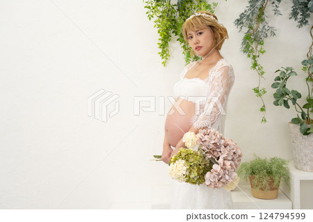 Pregnant woman with a bouquet Pregnant woman with a bouquet 124794599