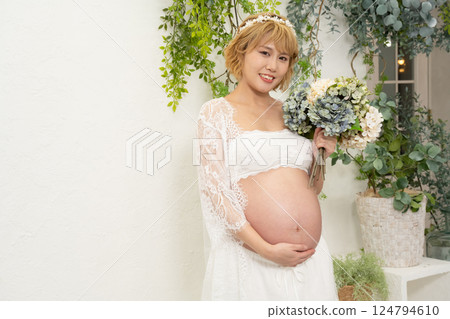 Pregnant woman with a bouquet Pregnant woman with a bouquet 124794610