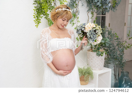 Pregnant woman with a bouquet Pregnant woman with a bouquet 124794612