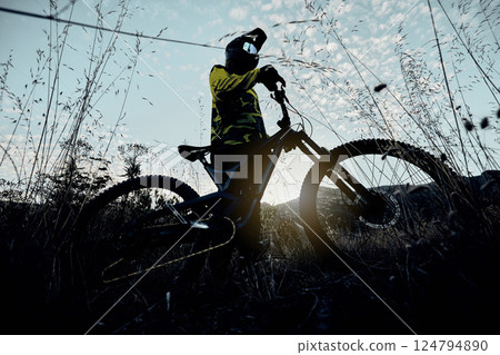 Nature cycling, blue sky and man with mountain bike for cardio workout, fitness journey or travel in countryside below view. Dark shadow flare, exercise and athlete rider training for triathlon race Nature cycling, blue sky and man with mountain bike for cardio workout, fitness journey or travel in countryside below view. Dark shadow flare, exercise and athlete rider training for triathlon race 124794890