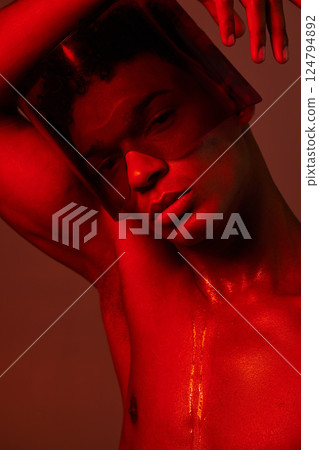 cyberpunk, man and red neon light studio for futuristic eyewear fashion aesthetic. Creative art design, vaporwave glasses and model face in graphic red background for future metaverse beauty portrait 124794892