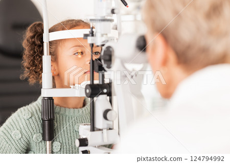 Child, kid or girl in optometry eye exam with optometrist, ophthalmologist or consulting medical profession and clinic slit lamp. Eye test, children eye care or vision check for healthcare insurance 124794992