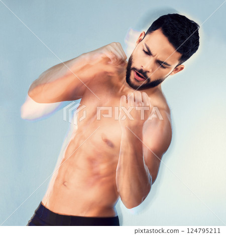 Fitness, studio and man shadow boxing for exercise, wellness or strength on a blue background. Sports, health and boxer or male fitness model from India practicing punch during workout or training. 124795211