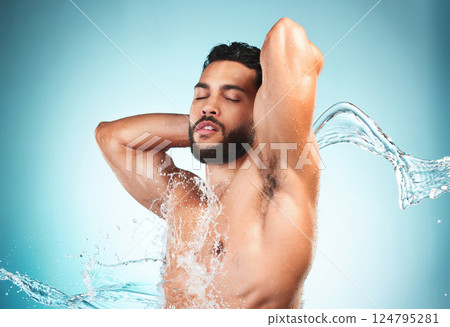 Beauty, shower and water with a man model in studio on a blue background for hygiene or hydration. Wellness, cleaning and splash with a handsome young male washing or cleansing in the bathroom alone Beauty, shower and water with a man model in studio on a blue background for hygiene or hydration. Wellness, cleaning and splash with a handsome young male washing or cleansing in the bathroom alone 124795281
