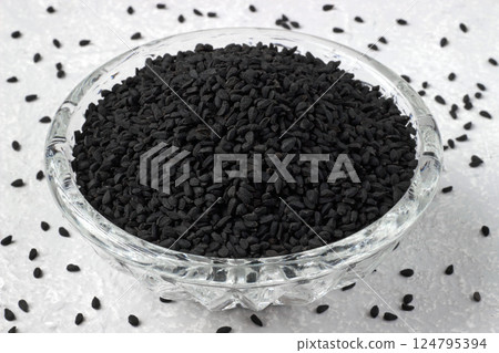 black cumin Nigella sativa in glass bowl on grey kitchen table black cumin Nigella sativa in glass bowl on grey kitchen table 124795394