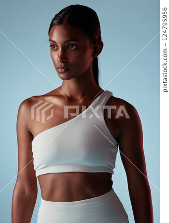 Fitness, health and sports black woman on studio blue mock up for fashion advertising or marketing. Mission, goal and focus athlete with skin health, glow and exercise wellness lifestyle with mockup Fitness, health and sports black woman on studio blue mock up for fashion advertising or marketing. Mission, goal and focus athlete with skin health, glow and exercise wellness lifestyle with mockup 124795956
