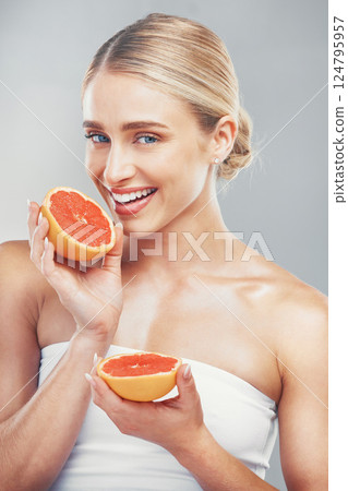 Woman, face and grapefruit body wellness care for healthy skin lifestyle. Vitamin c, luxury citrus fruit and cosmetic beauty model for natural skincare glow or makeup in grey background studio Woman, face and grapefruit body wellness care for healthy skin lifestyle. Vitamin c, luxury citrus fruit and cosmetic beauty model for natural skincare glow or makeup in grey background studio 124795957