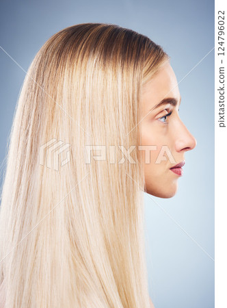 Woman, side and hair with beauty, blonde and studio closeup by blue background for hair care. Model, girl and young blonde with makeup, cosmetics or shine on locks for wellness by cosmetic backdrop Woman, side and hair with beauty, blonde and studio closeup by blue background for hair care. Model, girl and young blonde with makeup, cosmetics or shine on locks for wellness by cosmetic backdrop 124796022