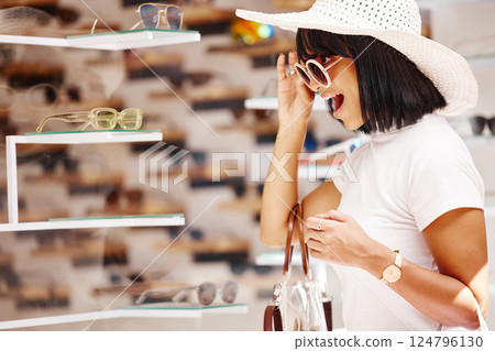 Retail, shopping and sunglasses store with woman and wow for sale, deal and fashion eyewear. Happy, market and smile with girl customer and window of mall or business for designer, gift or elegant Retail, shopping and sunglasses store with woman and wow for sale, deal and fashion eyewear. Happy, market and smile with girl customer and window of mall or business for designer, gift or elegant 124796130