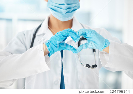 Doctor, hands and heart gesture in covid healthcare, love or trust for consultation or appointment at the hospital. Hand of medical GP showing hearty sign or emoji with mask during pandemic at clinic 124796144