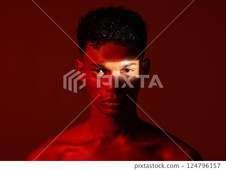 Beauty, red studio and portrait of a man with with a ray of light on his face with a skincare routine. Health, spotlight and model with a wellness skin treatment isolated by a brown background. 124796157