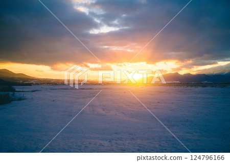 sunset over snowy landscape in winter sunset over snowy landscape in winter 124796166