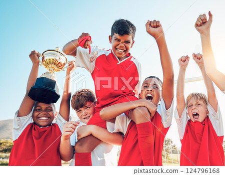 Soccer, celebration and kids team with trophy on soccer field, happy and excited at winning game. Sports, boy children goal and success in teamwork at football with gold medal award with winner smile 124796168