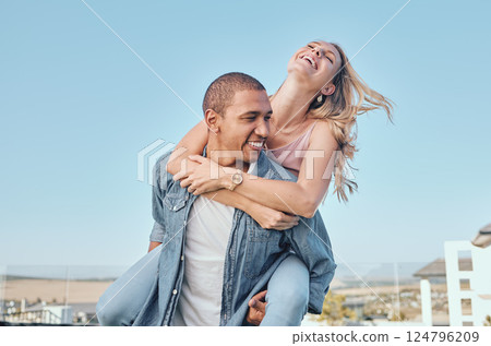 Interracial, couple and piggy back with outdoor fun of a happy girlfriend and boyfriend feeling love. Happiness of a woman and man together for anniversary or engagement announcement with a smile Interracial, couple and piggy back with outdoor fun of a happy girlfriend and boyfriend feeling love. Happiness of a woman and man together for anniversary or engagement announcement with a smile 124796209