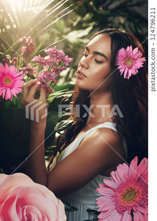 Flowers, gardening and woman in a forest, nature or park for peace, zen or wellness. Spring, plants and model in a garden with an aster flower and floral natural environment with trees in summer 124796211