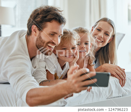 Happy family, selfie and smartphone in bedroom together for love, care or relax in family home in morning. Smile parents, excited children and cellphone of digital photo, fun and happiness lifestyle 124796223