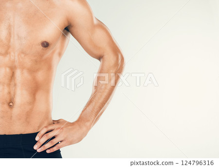 Muscular, man and fitness in studio zoom in for health, wellness and muscle in studio background with mockup space. Stomach, skincare and guy model torso for six pack, beauty and grooming or mock up 124796316