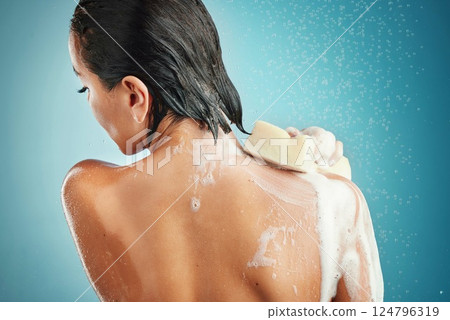 Water, soap shower and cleaning of a woman for hygiene and washing with cosmetic sponge. Person in a bathroom using foam to clean body, skin and hair for skincare wellness and natural beauty 124796319