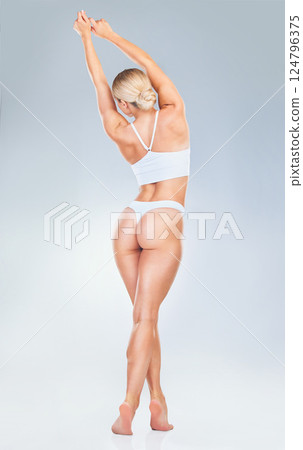 Beauty, woman and body wellness lingerie for nutrition diet, hair removal or liposuction product advertising. Back view of model girl with gray studio mock up for health or cosmetic marketing. 124796375