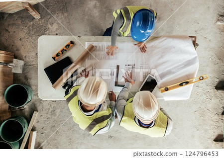 Architect, construction and blueprint with an engineer and designer team working on a building site from above. Meeting, planning and architecture with a design group in collaboration on a project Architect, construction and blueprint with an engineer and designer team working on a building site from above. Meeting, planning and architecture with a design group in collaboration on a project 124796453