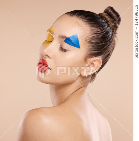 Woman, beauty and fine art makeup in cosmetics, facial or pose for colorful treatment against a studio background. Beautiful artistic female relaxed in calm satisfaction for creative cosmetic face 124796518