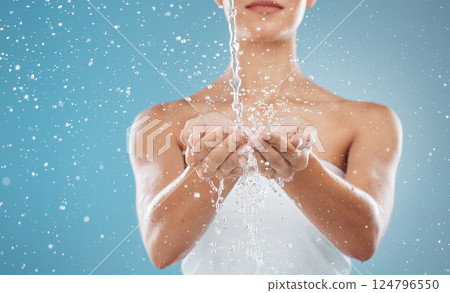Hands, splash and water for hygiene or grooming on a blue studio background. Skincare, wellness and health with a female cleaning, cleansing or washing her hands while isolated on a backdrop Hands, splash and water for hygiene or grooming on a blue studio background. Skincare, wellness and health with a female cleaning, cleansing or washing her hands while isolated on a backdrop 124796550