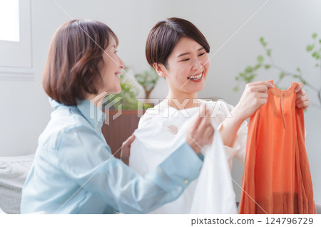 Parents and children buying clothes Parents and children buying clothes 124796729