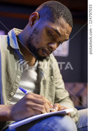 African american expert takes notes to evaluate legal economy balance on laptop, professional accountant checking capital funds development plan. Employee analyzing financial statistics. African american expert takes notes to evaluate legal economy balance on laptop, professional accountant checking capital funds development plan. Employee analyzing financial statistics. 124797035