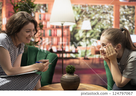 Therapy session where a teenager discusses her struggles with anxiety and social issues. Psychotherapist listening to young girl with intrusive thoughts, helping improve self esteem. Therapy session where a teenager discusses her struggles with anxiety and social issues. Psychotherapist listening to young girl with intrusive thoughts, helping improve self esteem. 124797067