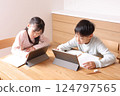 Elementary school boys and girls studying on tablets 124797565