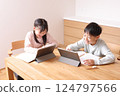 Elementary school boys and girls studying on tablets 124797566