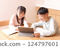Elementary school boys and girls studying on tablets 124797601