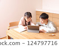 Elementary school boys and girls studying on tablets 124797716