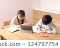 Elementary school boys and girls studying on tablets 124797754