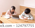 Elementary school boys and girls studying on tablets 124797755