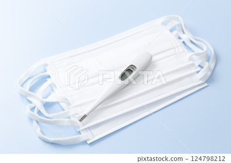 Mask and thermometer on blue background 124798212