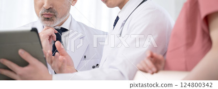 A banner of doctors in a medical team checking the status of medical records and examinations, without faces, a supervising doctor and a trainee doctor A banner of doctors in a medical team checking the status of medical records and examinations, without faces, a supervising doctor and a trainee doctor 124800342