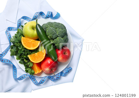 A vibrant display of fresh fruits and vegetables symbolizes healthy living, laid on a lab coat, isolated on white, PNG A vibrant display of fresh fruits and vegetables symbolizes healthy living, laid on a lab coat, isolated on white, PNG 124801199