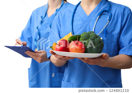 Medical personnel present a variety of healthy food choices to emphasize nutrition awareness, isolated on white, PNG 124801210